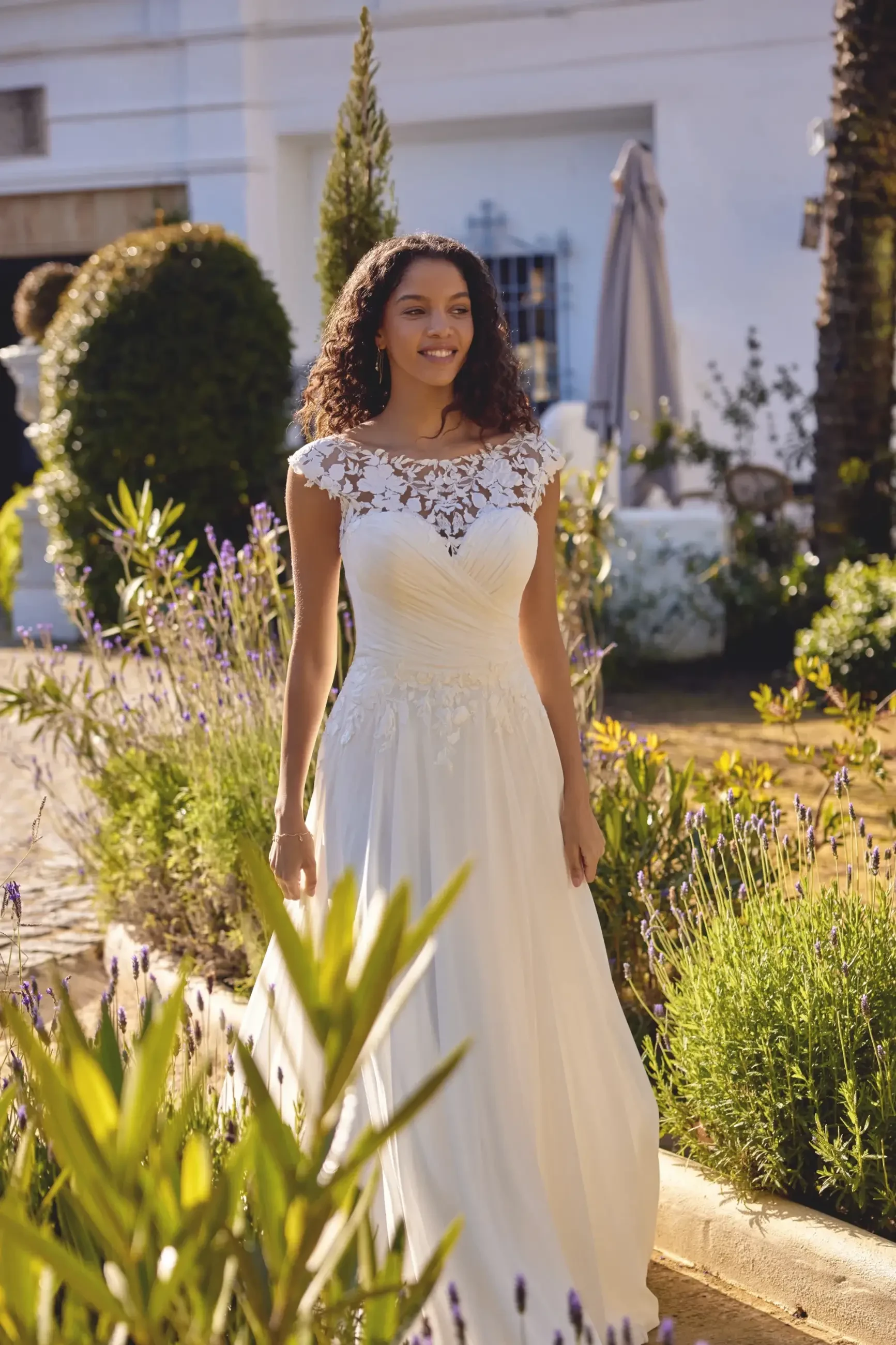 model is wearing a short sleeve a-line bridal gown
