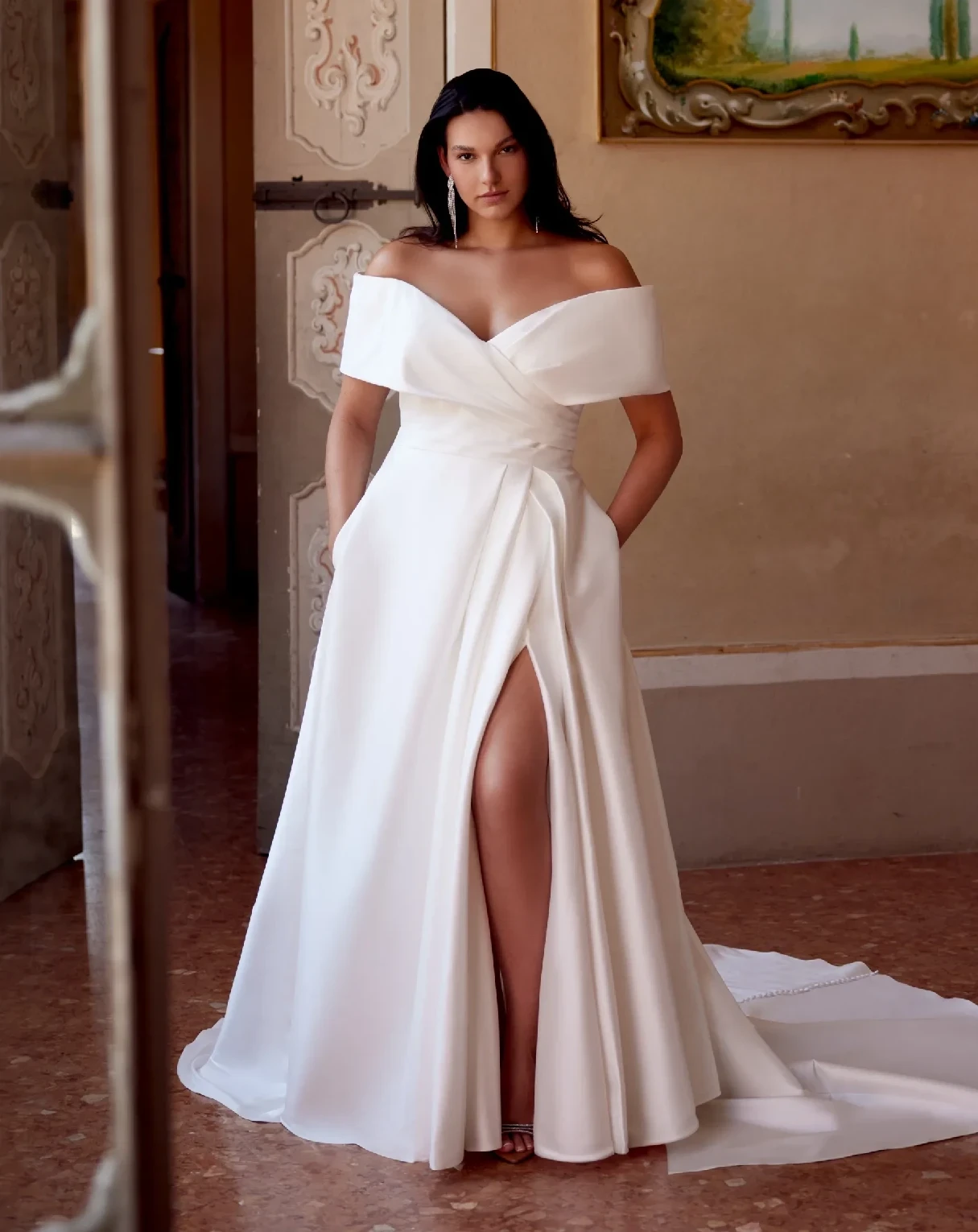 Models wearing a gown by Justin AleXander