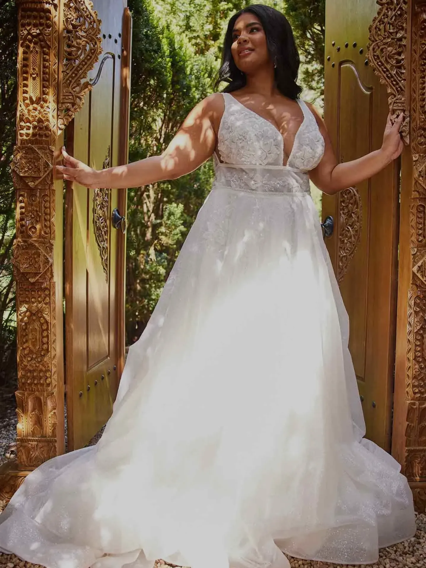 Model wearing plus size wedding gown